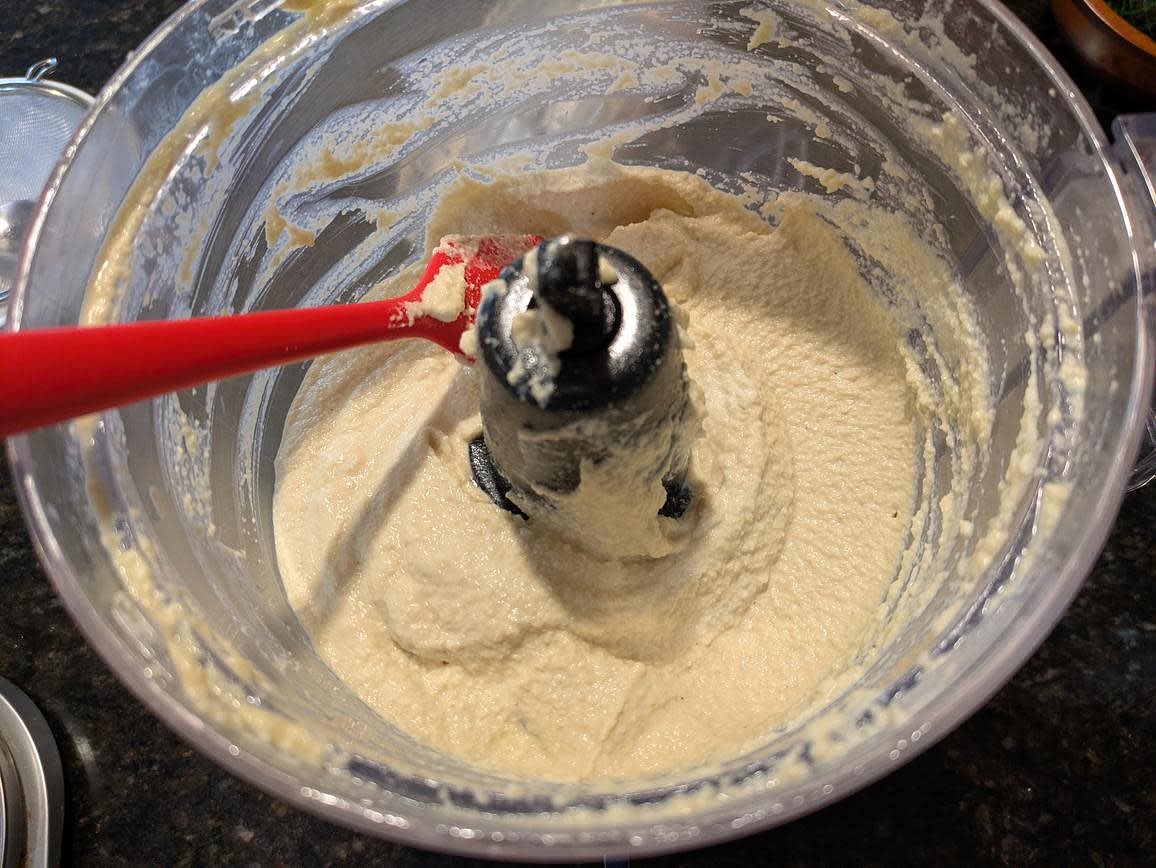 Add the soaked cashews and water to a food processor or blender, along with lemon juice, apple cider vinegar, nutritional yeast, garlic, and salt. Blend until smooth