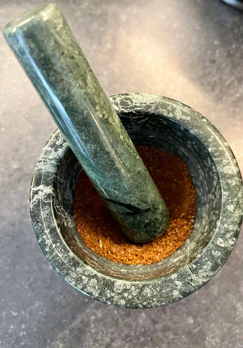 Heat a large frying pan to medium heat, add the cumin seeds and coriander seeds and toast until fragrant (for about a minute), then put the toasted seeds in a mortar together with the ground cinnamon, cayenne pepper and a pinch of salt, and ground them together to a powder. Put it to the side.