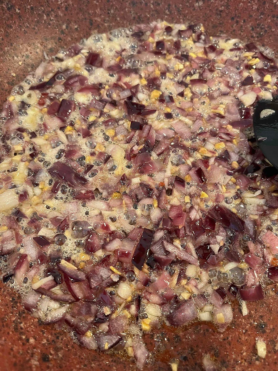 Put the frying pan back to medium heat , heat the oil, then add the onion, ginger and garlic, and fry them till tender (2 to 3 minutes).