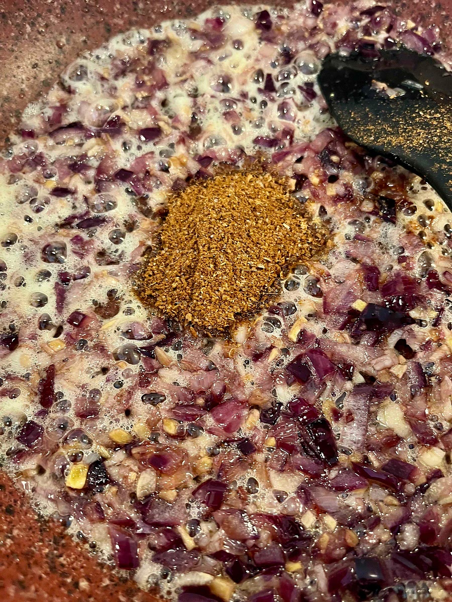 Add the ground spices and stir to coat all the aromatics, frying them por about a minute.