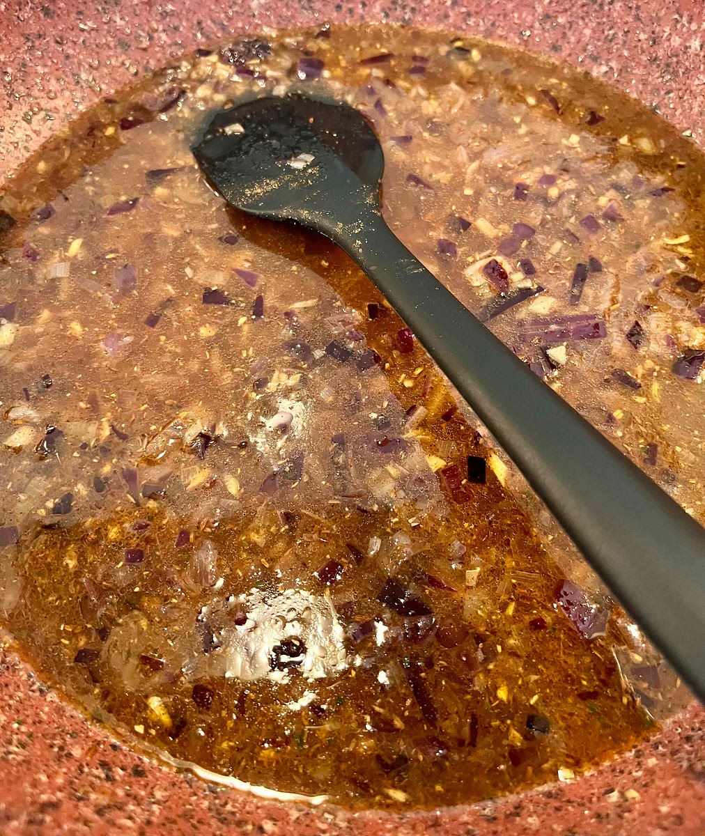 Add the veg stock and deglaze the pan.