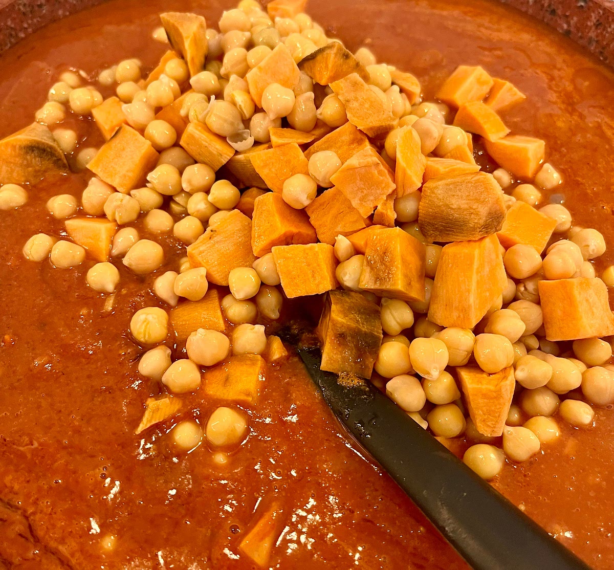 Add the sweet potatoes and chickpeas and stir well to integrate.