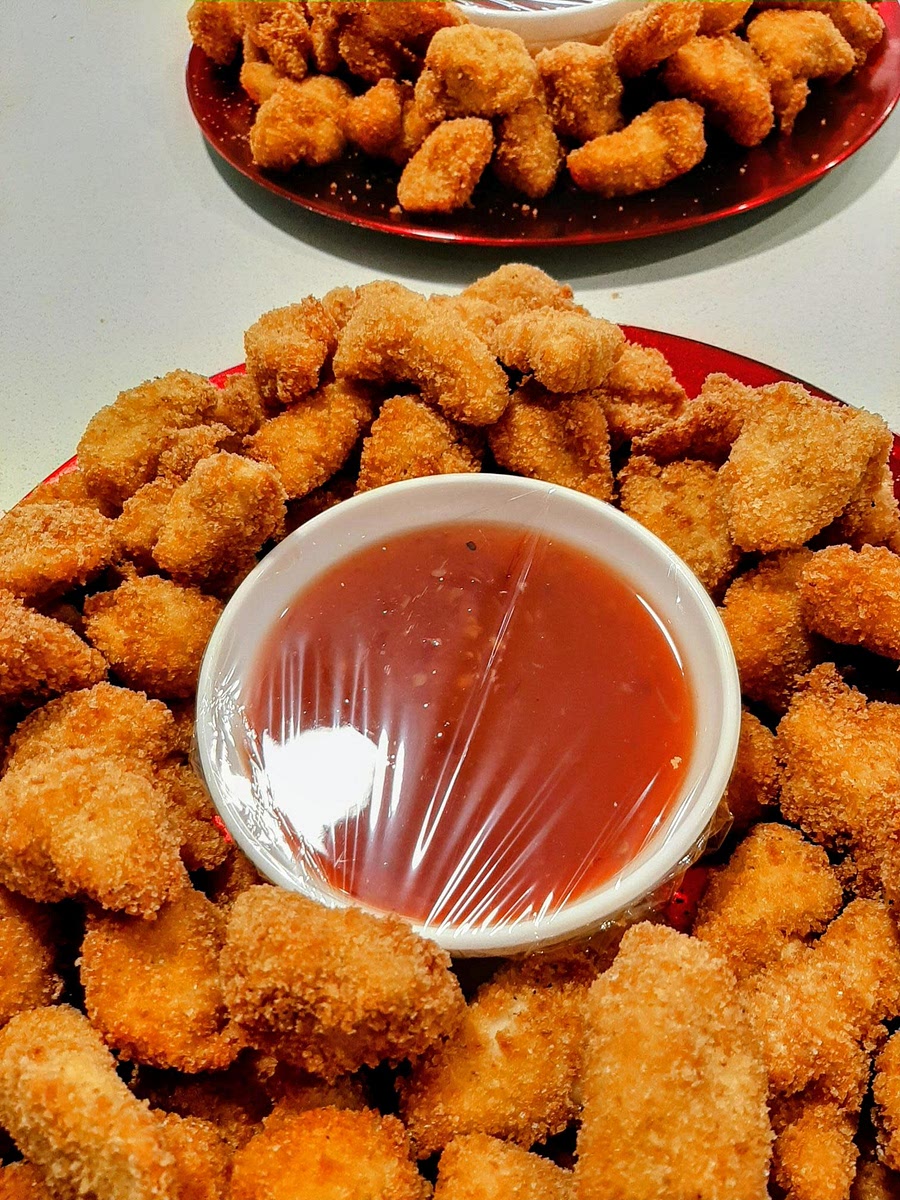 Trim chicken tenders, removing sinew and tendon (a tough white string), then cut it in bite size pieces. Drizzle some oil on the chicken pieces, then season with vegeta and black pepper. Beat the eggs in a wide bowl (like a soup bowl) with a couple of tablespoons of cold water. Place the flour and the breadcrumbs in 2 separate Ziplock bags, large enough to contain the chicken pieces. Add the chicken to the bag with flour, then lift the pieces up with your fingers, shaking any excess flour. Add them to eggs until they are all coated and then put them into the bag with breadcrumbs. You can do this in batches if you have a large quantity of chicken and increase the amount of flour, eggs and breadcrumbs accordingly. Heat about 1 cm oil in a frying pan (or you can cook them in the deep-fryer if you wish) and add only enough chicken to form one layer - overcrowding the pan will not make them nice and crispy. Fry the chicken turning it on all sides until nice and golden. Do not walk away as they cook really quickly and you might burn them! Remove them with a slotted spoon on paper towel to drain well any excess oil. Serve hot or cold with a dipping sauce (tomato sauce, ketchup or chili sauce) or as a main, with mashed potatoes and green salad.