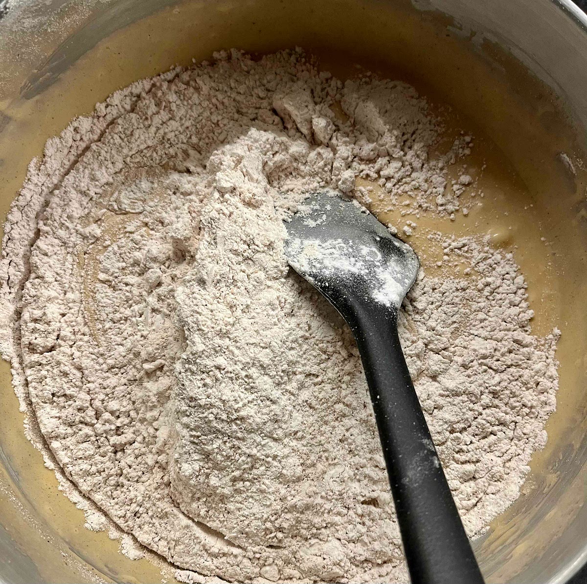 In a medium bowl, mix the flour, baking soda, salt, ground cinnamon and nutmeg, then stir the mix into the wet ingredients until integrated.