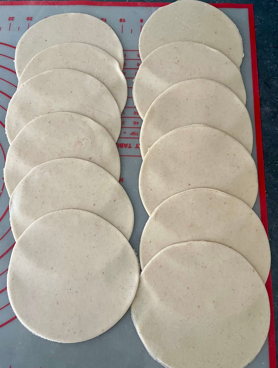 Lightly flour the working surface and, with a rolling pin roll out each ball into discs until their thickness is about 2mm. If you want them perfectly circular(they should be roughly round, but don’t need to be perfect) you can use a 12cm round cutter.