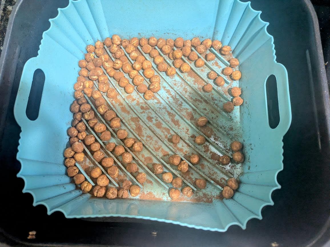 Preheat your air fryer to 380F, and drain and rinse a can of chickpeas. Add to a bowl, and toss with cinnamon. Air fry for about 15 minutes, shaking halfway, until golden and crispy