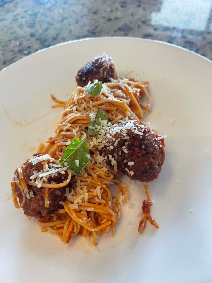 Add your cooked pasta and some pasta water to the sauce and meatballs. Then plate and enjoy!