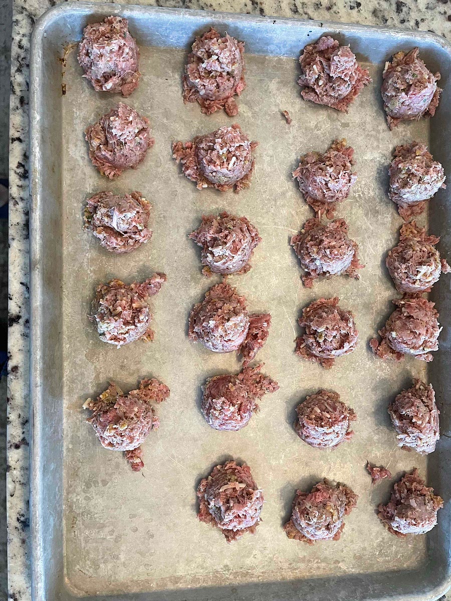 Using a cookie scoop, scoop the meat mixture onto a baking sheet.