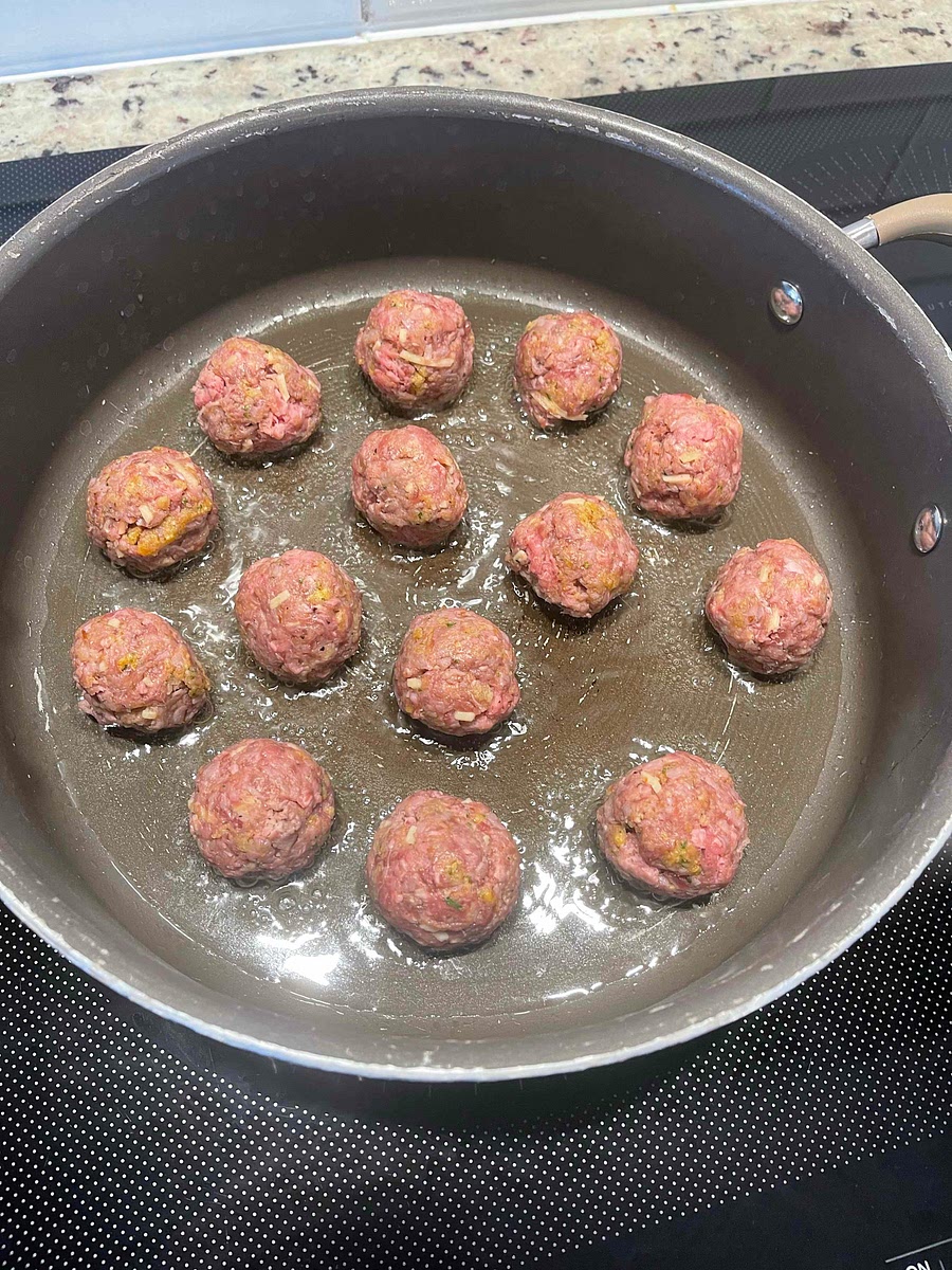 Heat the oil in a pan over high. Sear your meatballs without overcrowding the pan.