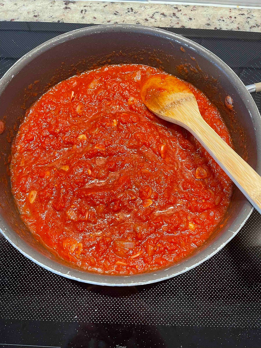 Add the crushed tomatoes (canned).