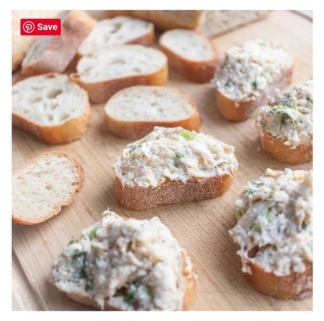 Spread the seafood mixture onto the sliced bread using a large spoon.