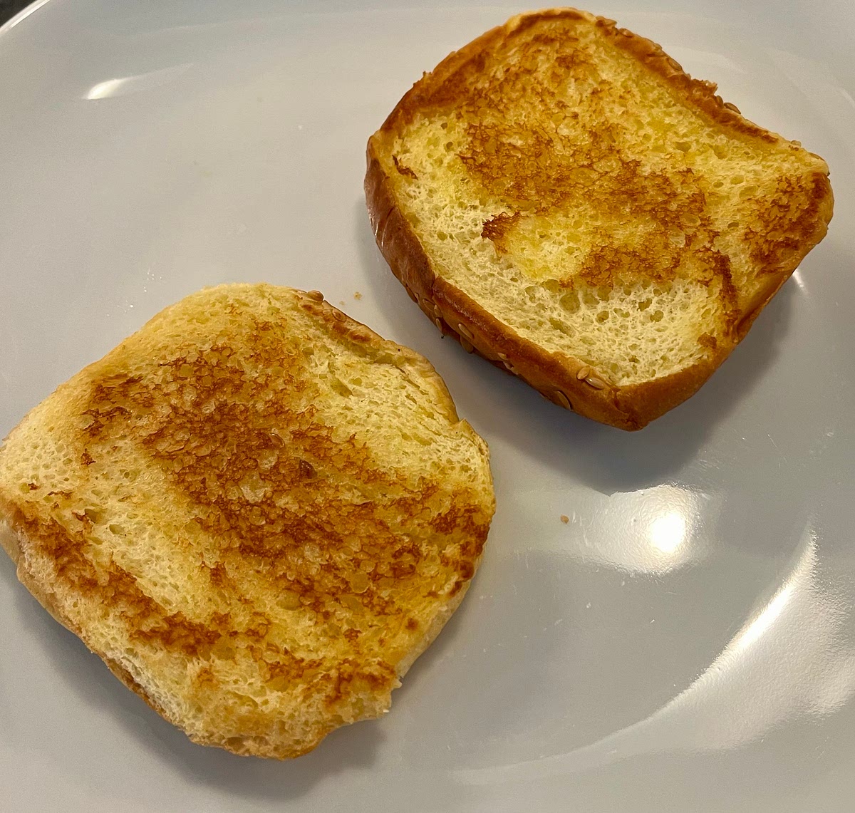 Add the butter to a non stick frying pan and toast the inside of the burger buns in it.
