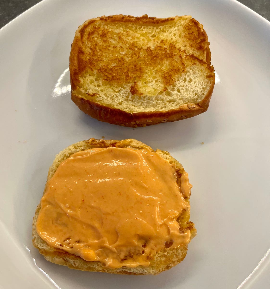 While they cook, mix the mayo and the sriracha and spread on the inside of the lower side of the buns.