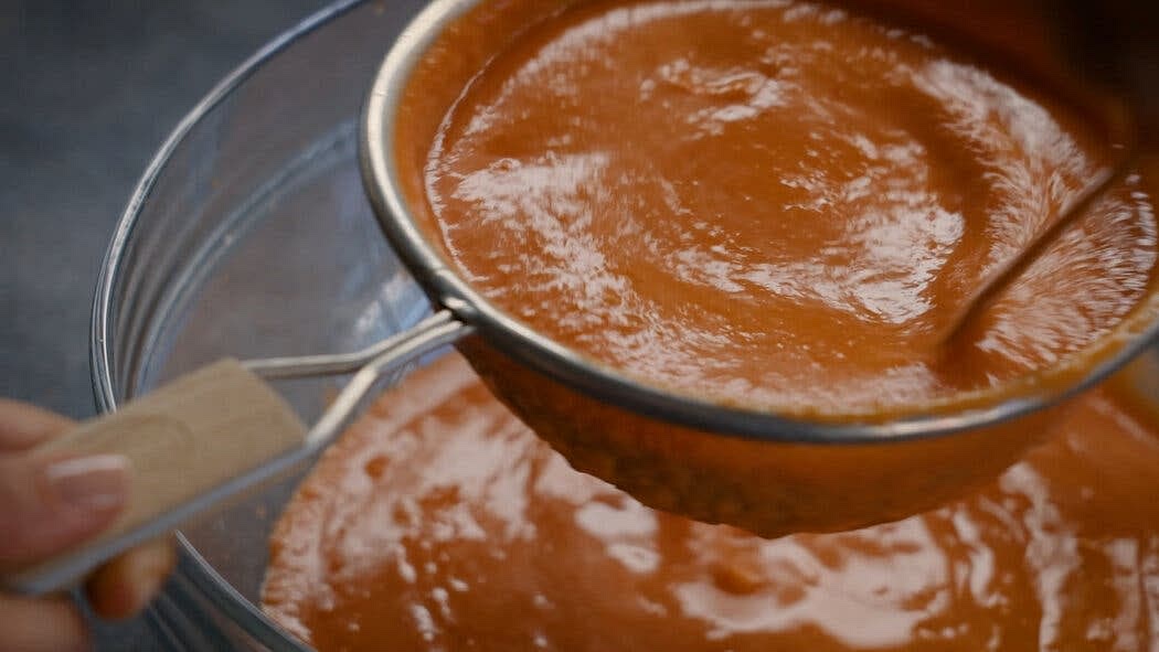 Strain the mixture through a strainer or a food mill, pushing all the liquid through with a spatula or the back of a ladle. Discard the solids. Transfer to a large pitcher (preferably glass) and chill until very cold, at least 6 hours or overnight.