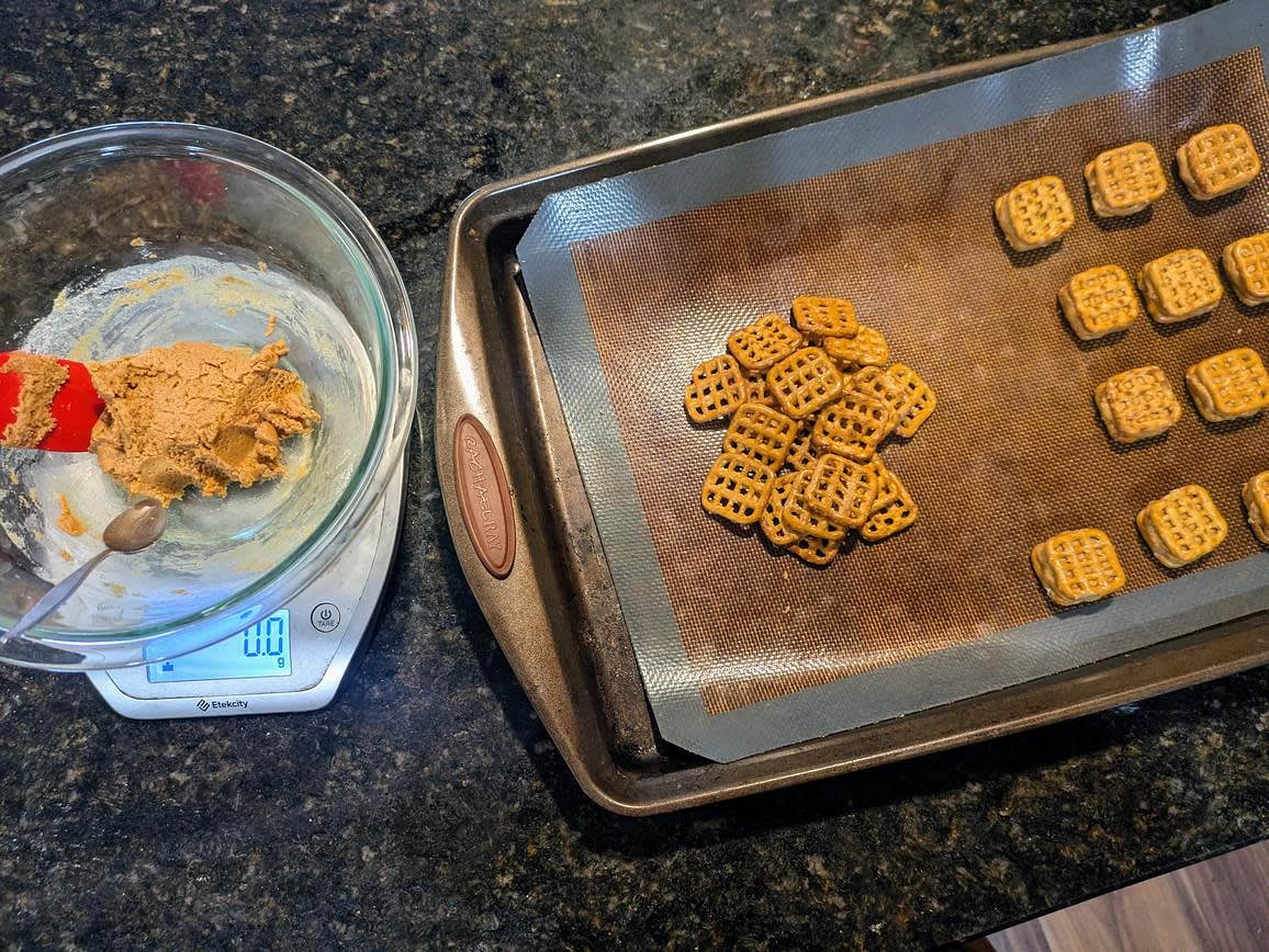 Line a baking sheet with parchment paper, and prepare 48 pretzels. Place a small scoop of the dough (about 7 g) onto 1 pretzel, and sandwich with another on top. Add to the sheet, and repeat to make 24 pretzel nuggets