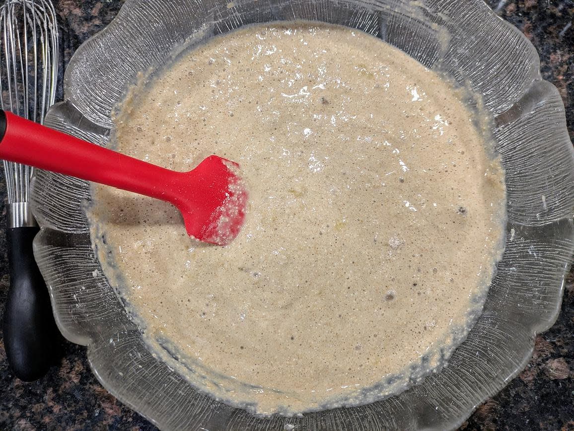 Add the wet ingredients into the dry, and mix with a silicone spatula until just fully combined. Don't over mix. Optionally, fold in 1/2 cup (85 g) chopped walnuts or chocolate chips