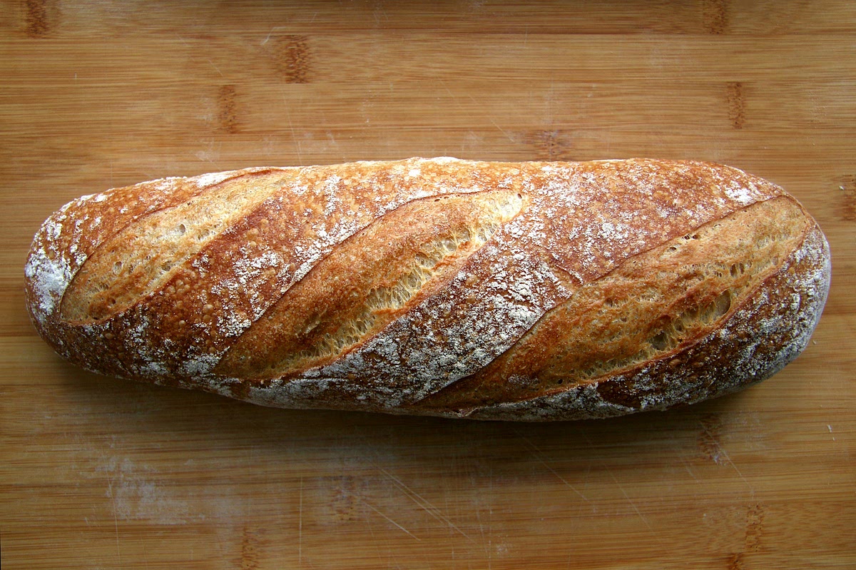 Slice the loaf of bread in half lengthwise