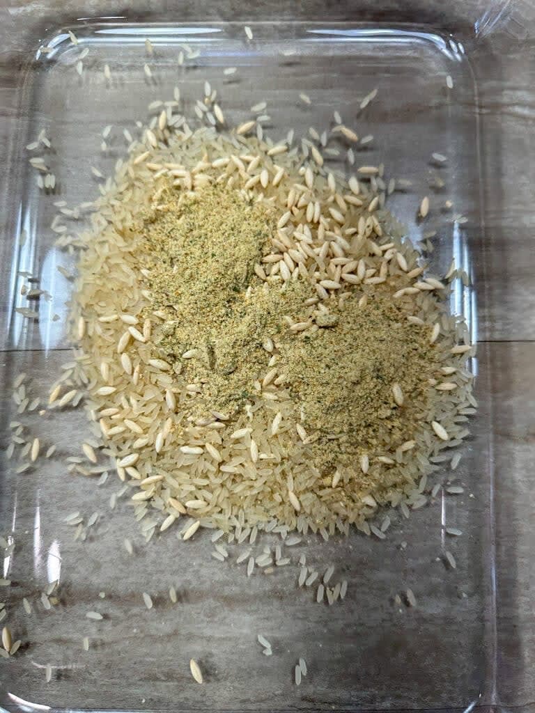 Add the rice and seasoning to the casserole dish and mix together.
