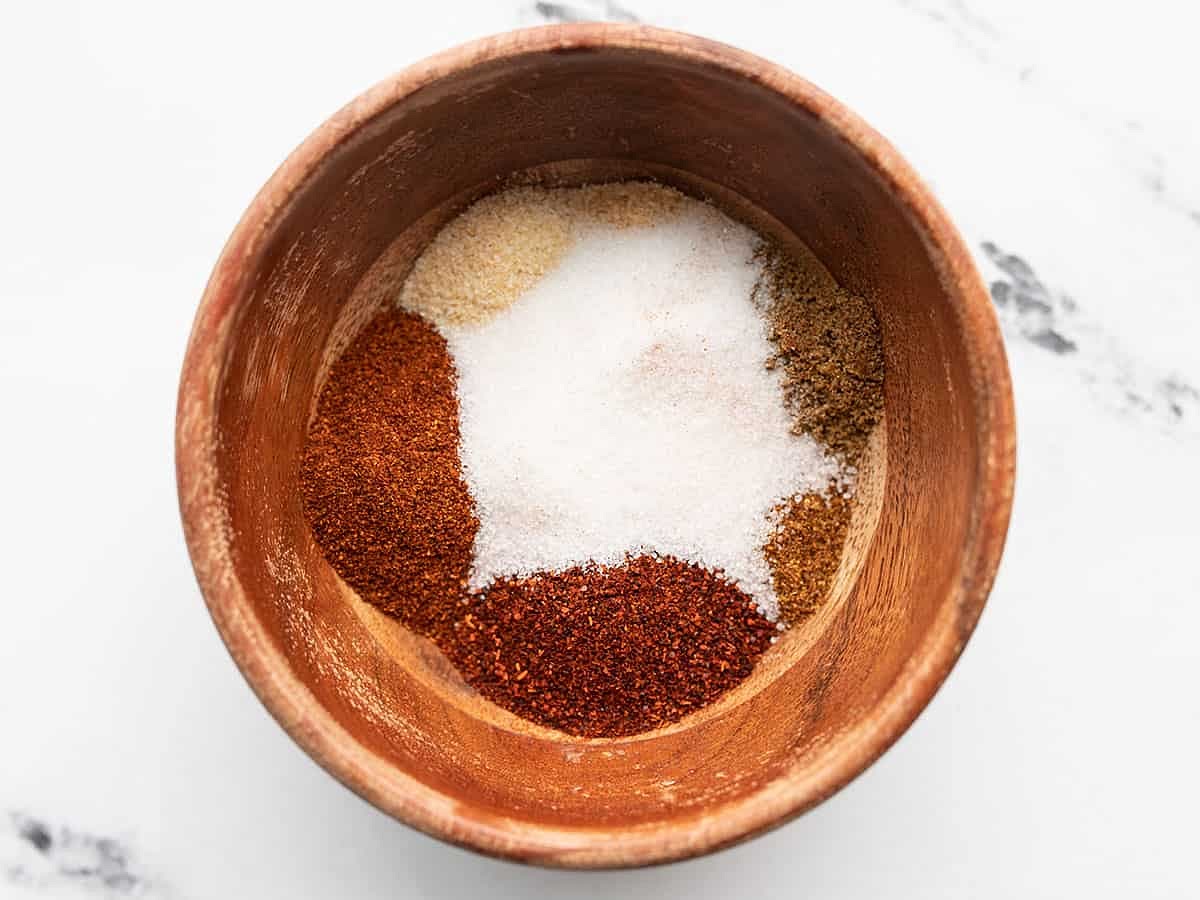 Preheat the oven to 400°F. Mix all of the spices for the fajita seasoning in a small bowl and set aside (chili powder, paprika, onion powder, garlic powder, cumin, cayenne pepper, sugar, and salt).