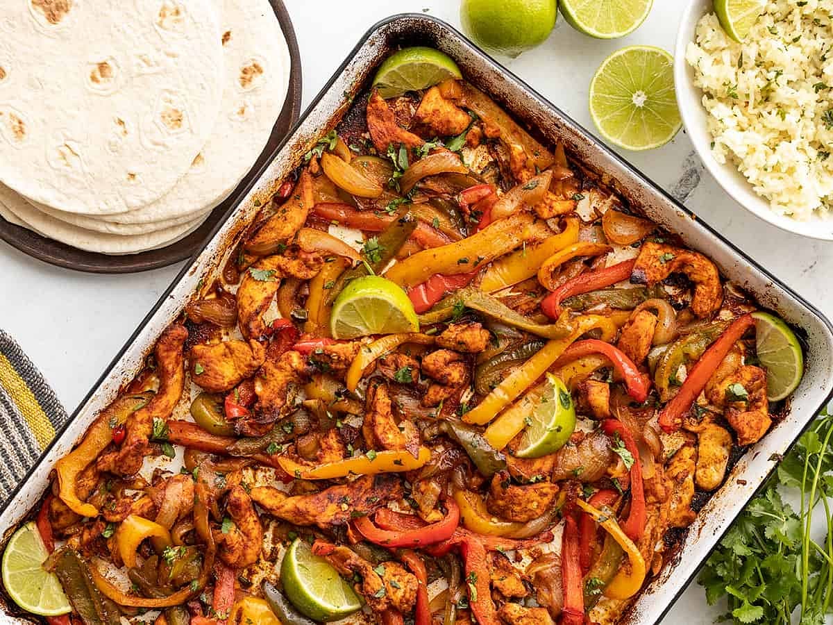 Bake the chicken and vegetables in the preheated oven for 35-40 minutes, stirring once halfway through. Squeeze the juice from half of the lime over top of the meat and vegetables after they come out of the oven.