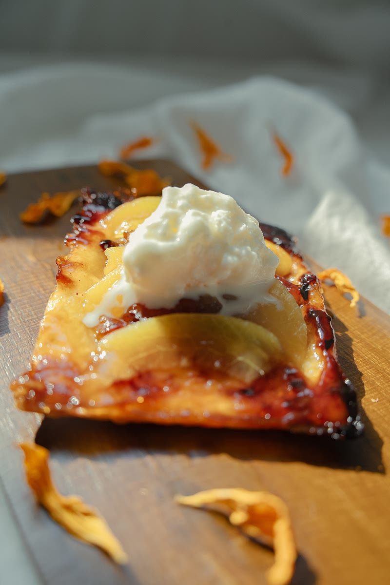 Carefully turn pastries upside down so the peaches are on top. Serve warm with a scoop of vanilla ice cream and a little extra cinnamon dusted over.