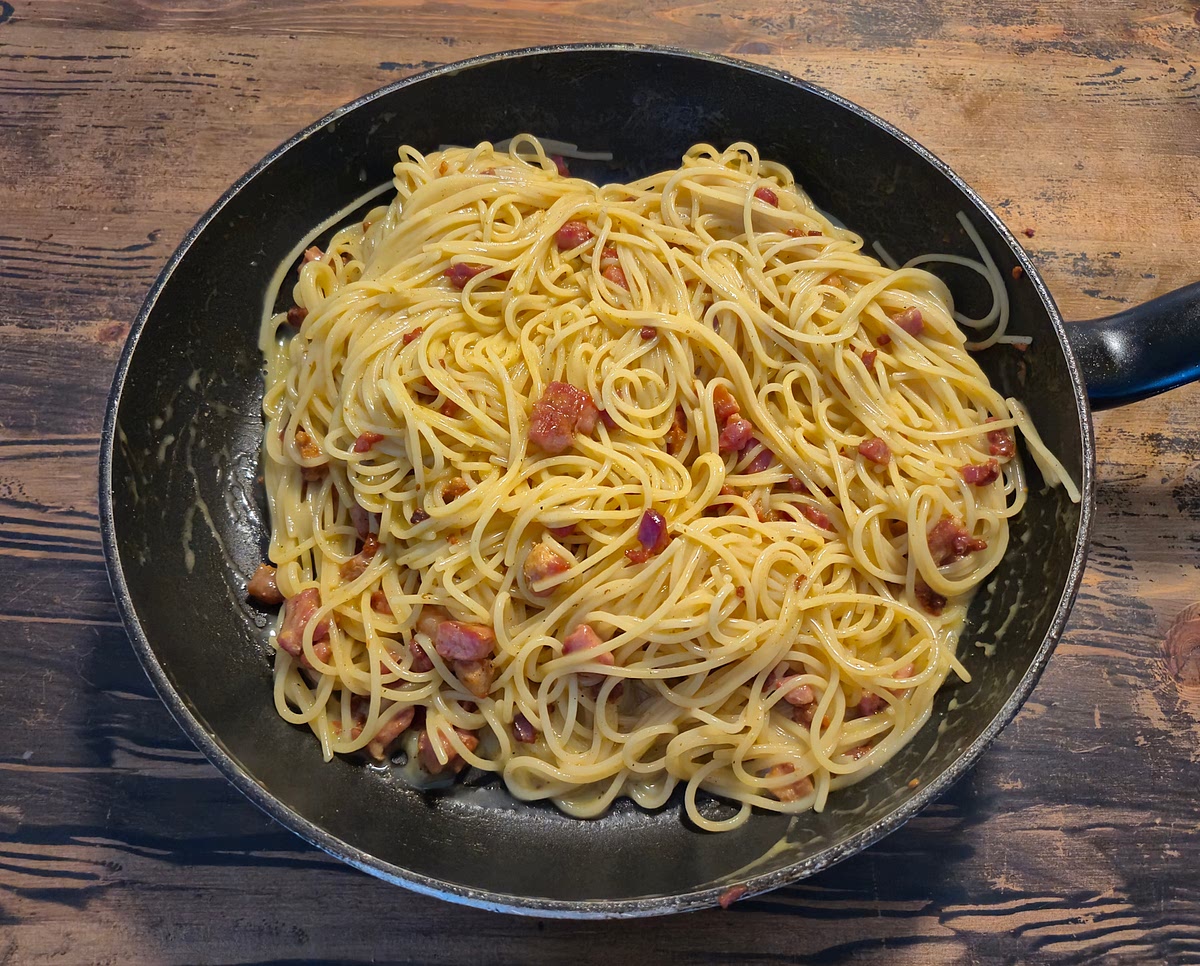 Add the dish to a bowl, and top it off with a bit of grated parmesan and black pepper
