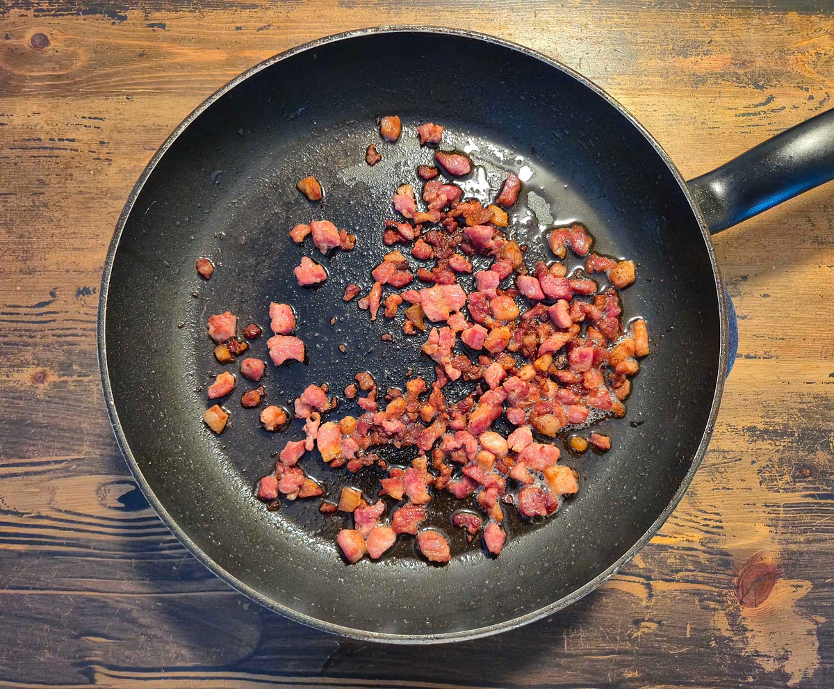 Add 200g bacon cubes into a cold pan. Let it sit on low heat for around 30 minutes until it becomes crispy.