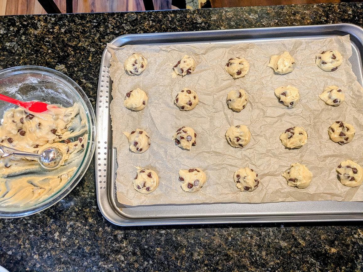 Using a 1 tbsp cookie scoop, scoop the cookies onto the parchment lined trays. Leave about 1-2 inches between each cookie, as they'll flatten and spread as they bake