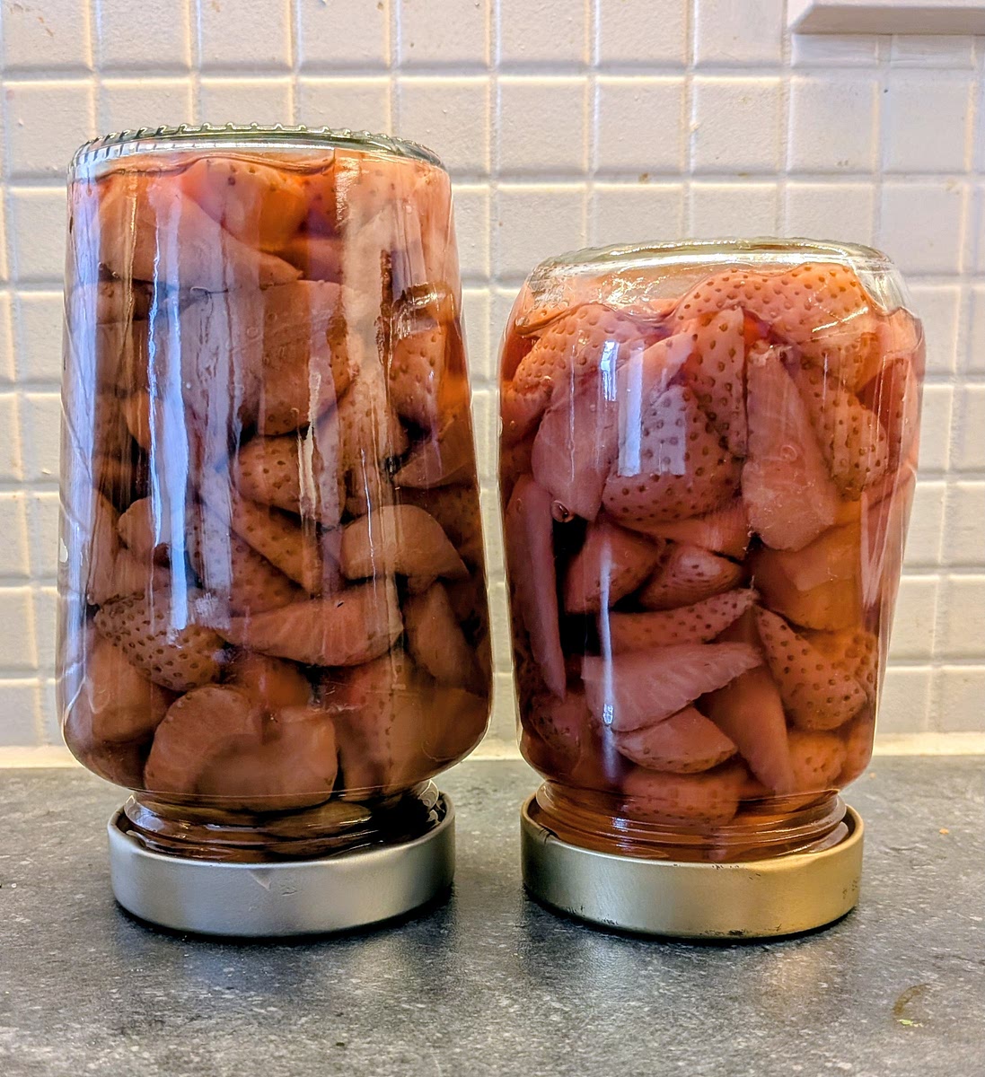 Optional: if you are brave, you can eat the boozy strawberries (don’t eat too many, it’s potent stuff... will grow hair on your chest 😜). You can also put them in a sterylised jar, add a squirt of the liquor for colour, fill the jar with warm simple syrup (you'll need to make a bit more in the next step), and close the lid. Let it cool down upside down so the little air in the jar compresses and makes a tight seal.