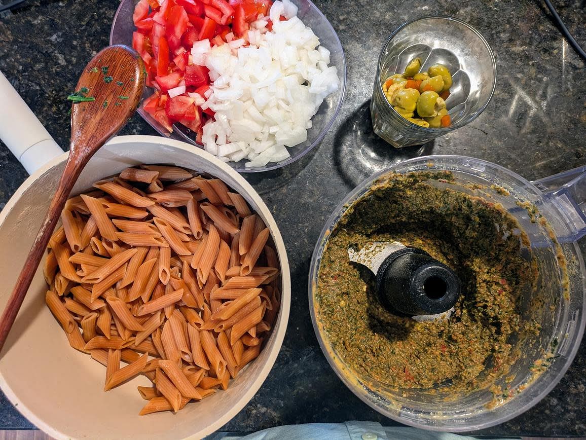Add your sun dried tomatoes to the food processor, and pulse until roughly chopped. Add in the spinach and the rest of the dressing ingredients, and blend until well combined. Thin out with water as needed