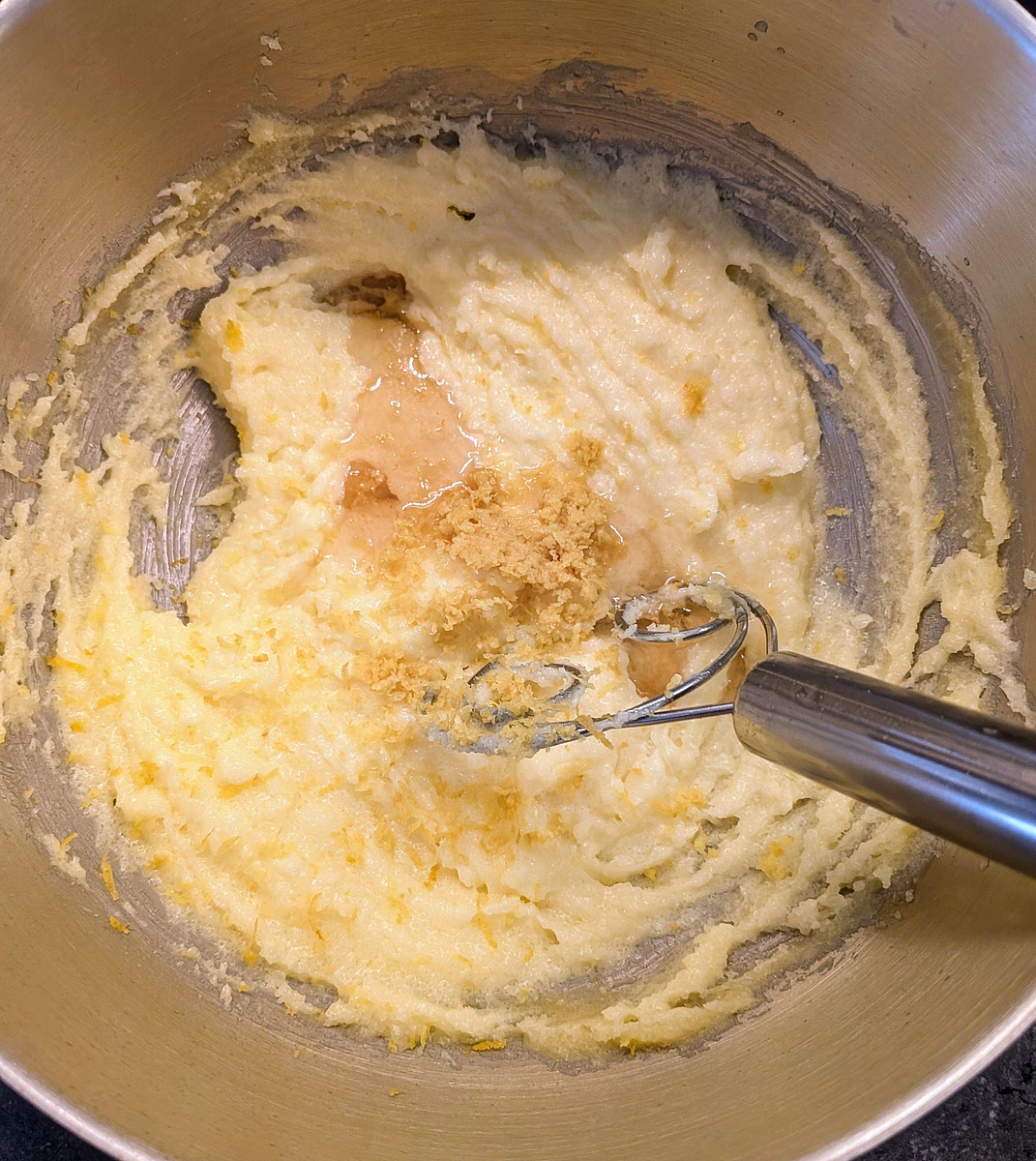 Now you need to flavour / perfume the mix. Add the vanilla extract and the zest of 1 large orange and mix until integrated.
You can also do this step in a mixer with a beater attachment, but I prefer hand mixing it to minimise the heat added to the the dough.