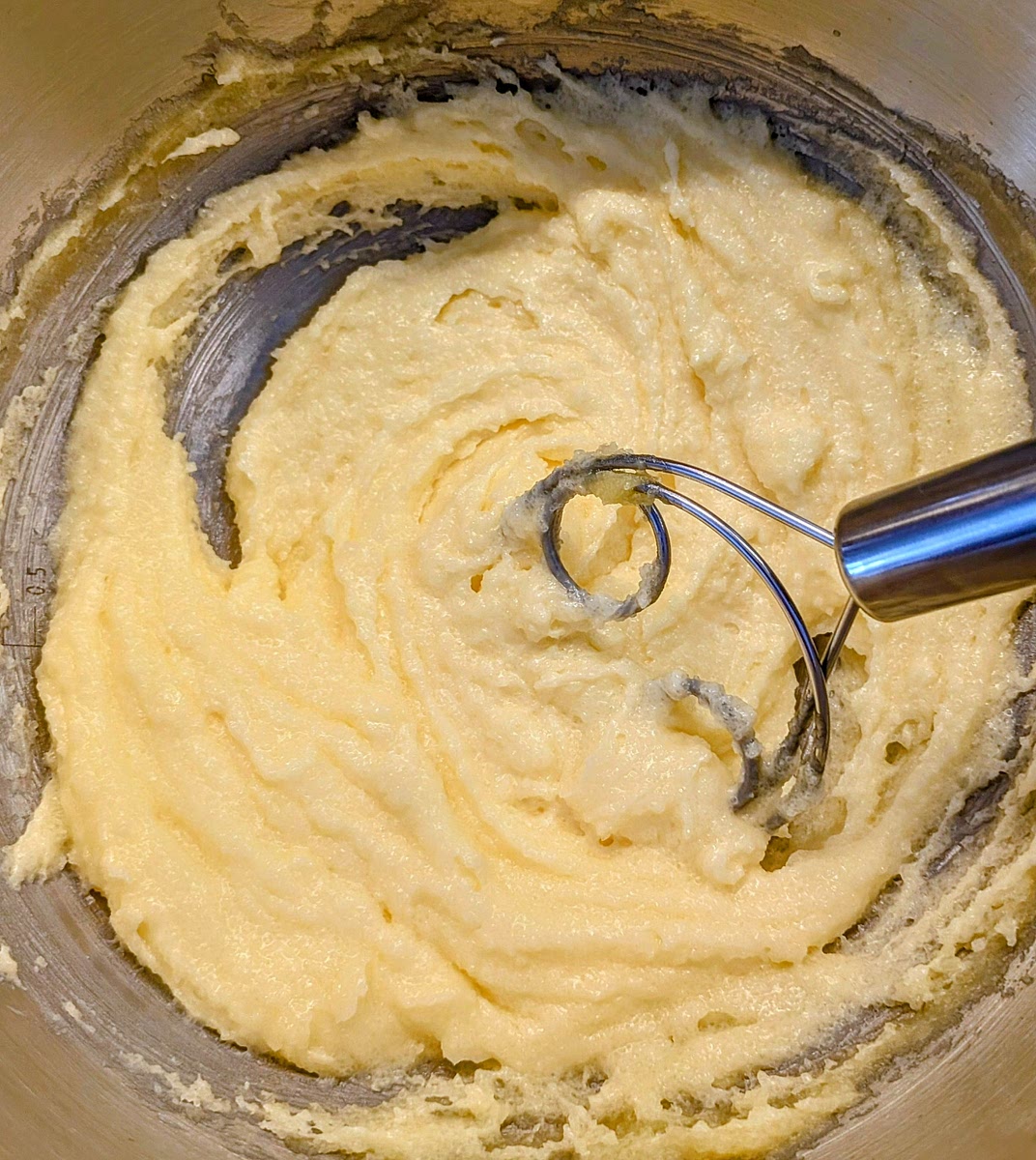 In a large bowl, add the soft (room temperature) butter and the sugar, and beat together with a pastry whisk until you get a creamy homogeneous mix. You can also do this step in a mixer with a beater attachment, but I prefer hand mixing it to minimise the heat added to the dough.