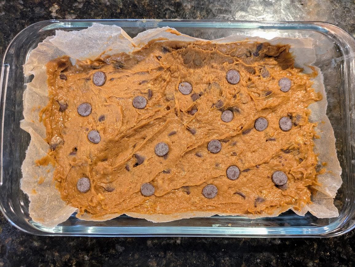 Line a small pan with parchment paper (mine is 10" x 6"). Spread the batter into the pan. It will be very sticky; be patient. Make sure it's an even thickness and spread to all edges. Optionally top with a few more chocolate chips