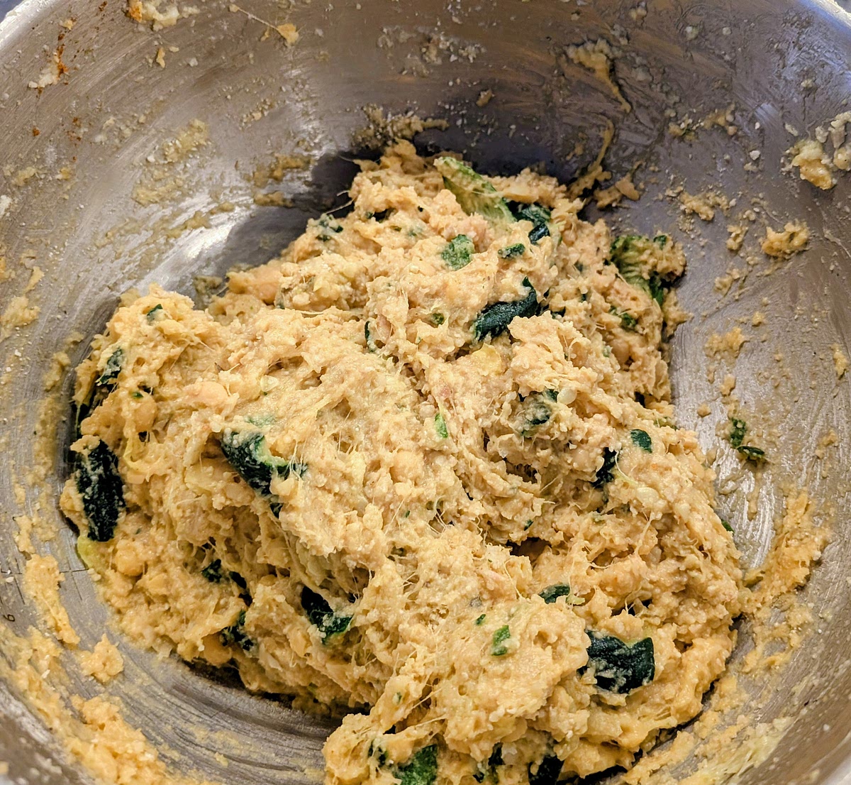 Mash and mix it all well with a potato masher. You are looking for a paste with not many lumps, so you may need to squeeze flat some chickpeas with your fingers or a fork, if they are a bit firm. The odd chickpea here or there is ok.