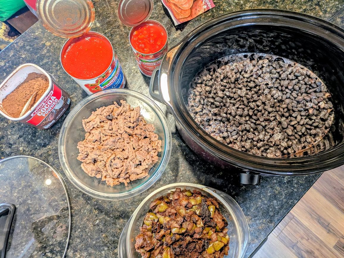 Combine together your beans, meat, veggies, canned tomatoes, and cocoa powder in the slow cooker