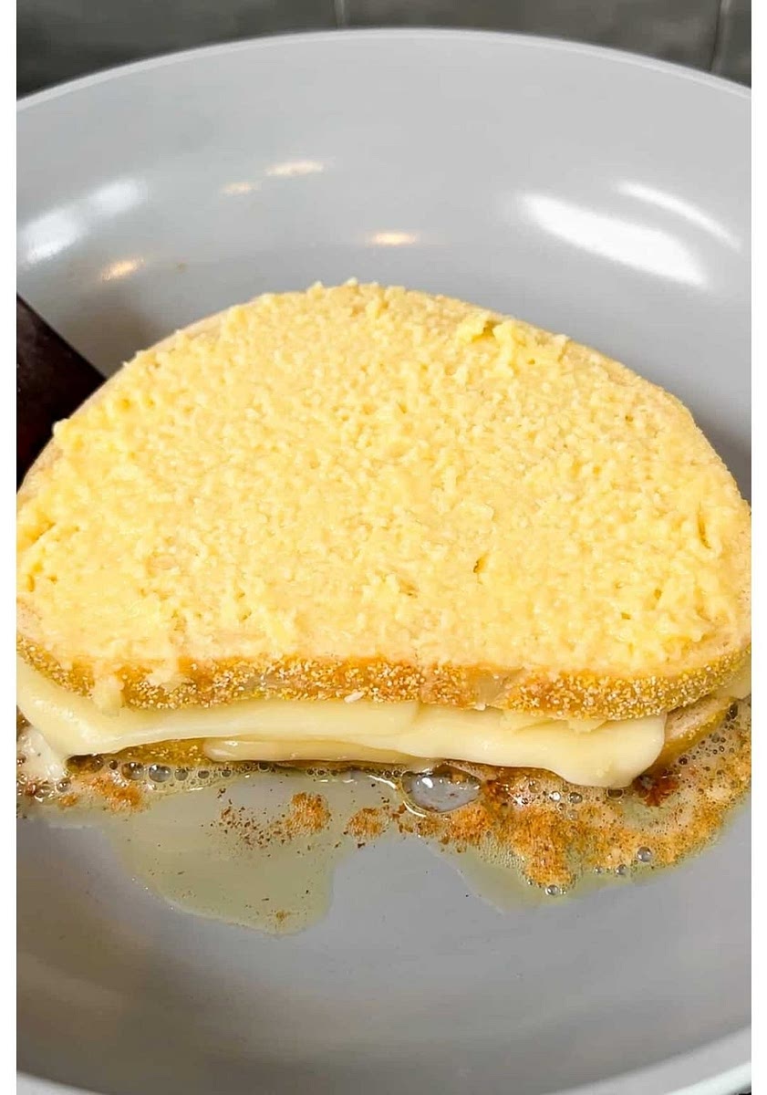 In a large nonstick skillet over low heat, add in the sandwich and cook about 5 minutes per side or until golden brown and toasted. Low and slow is key so the cheese melts before the bread browns too quickly. Remove the grilled cheese from the skillet, slice in half and enjoy immediately.