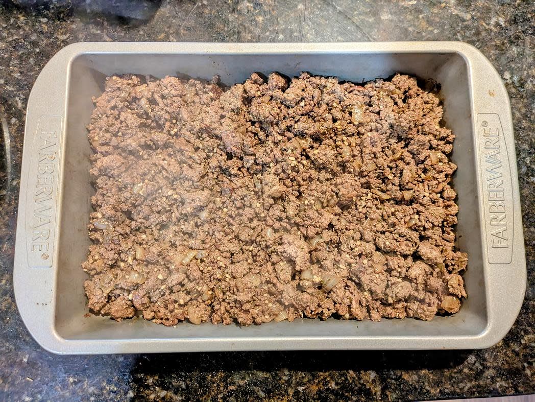 Add the liver and ground beef to the pan with the onions, and cook until browned and no longer pink. Add in your spices, and cook until fragrant, about 1 minute. Transfer the meat and onions to the baking dish