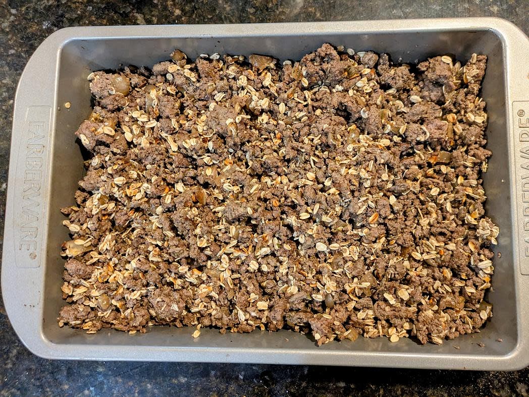 Transfer the oats to the baking dish with the meat. Pour in the water, and mix until fully combined