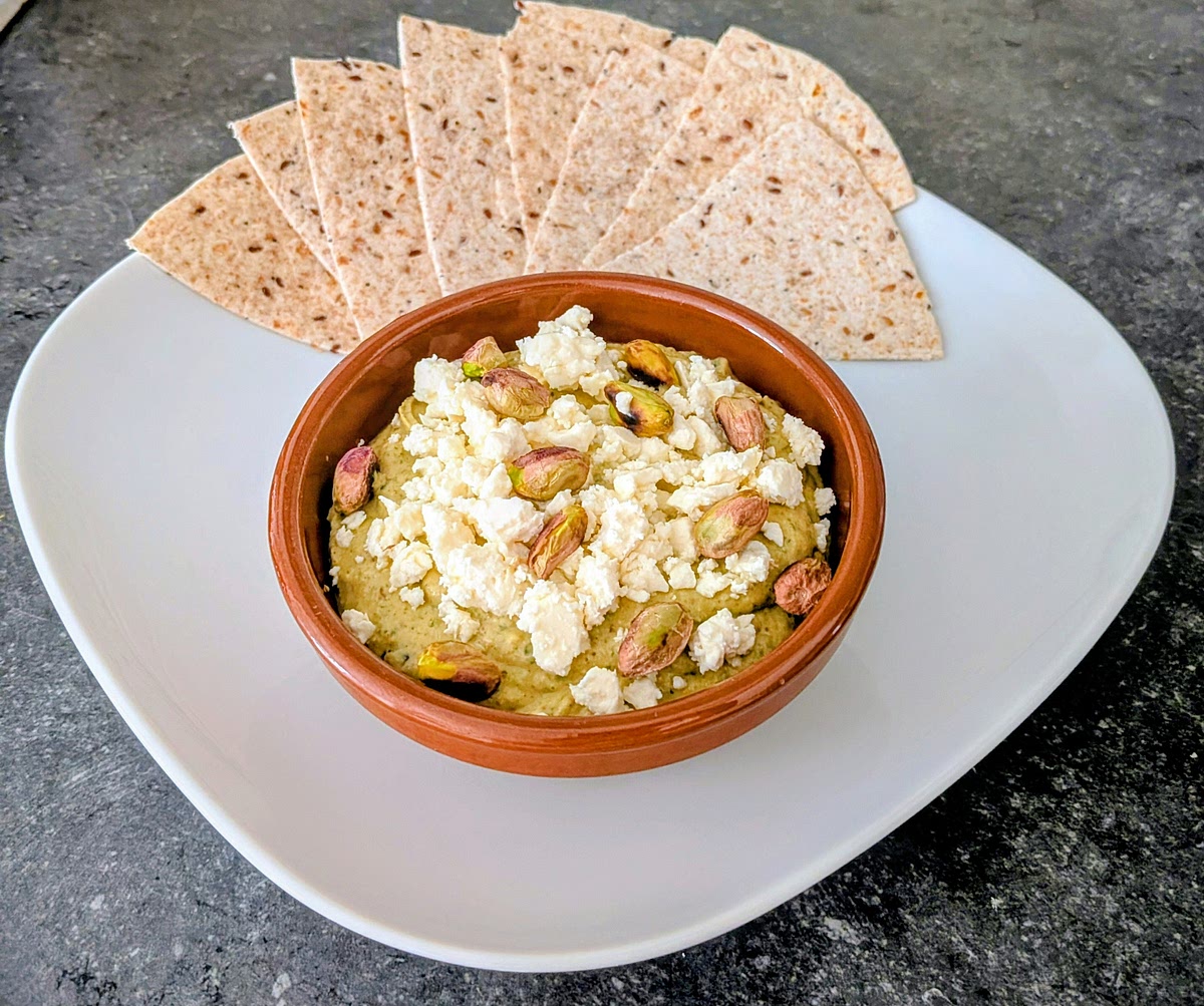 Pour the cream in a bowl, and top it with crumbled feta and the saved toasted pistachio kernels, and sprinkle the extra virgin olive oil. Serve it with seeded tortillas, sourdough bread, or pita bread. Enjoy!