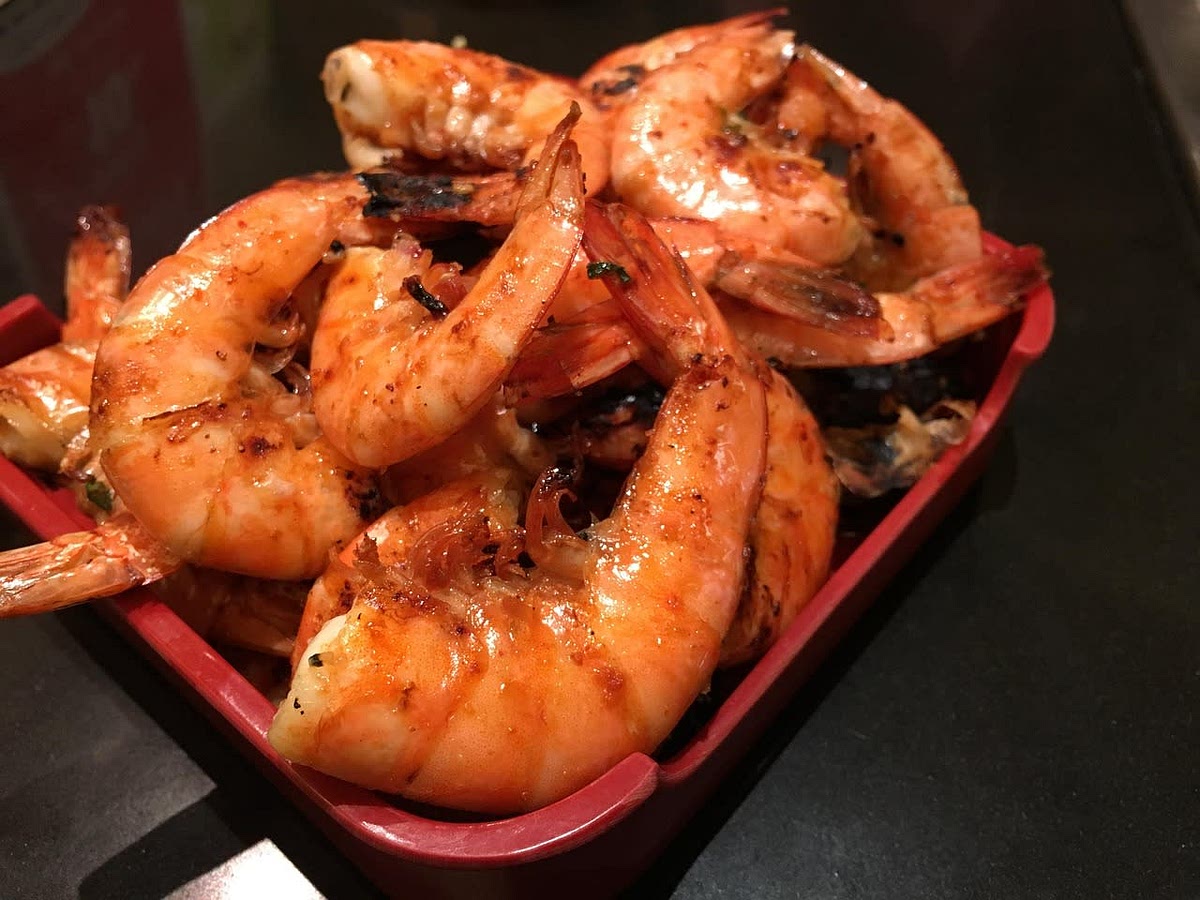 Drizzle olive oil over the prawns and dust them with paprika, garlic, salt, and pepper. Mix well, then bake the prawns in a 375°F convection oven for 10 minutes (we often use large, frozen easy-peel prawns). Peel to serve.
