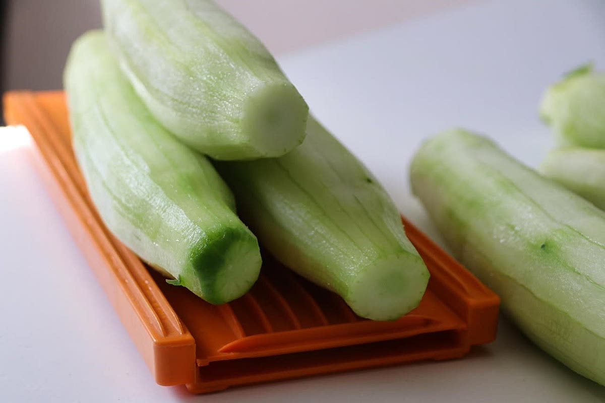 Peel and slice the cucumbers