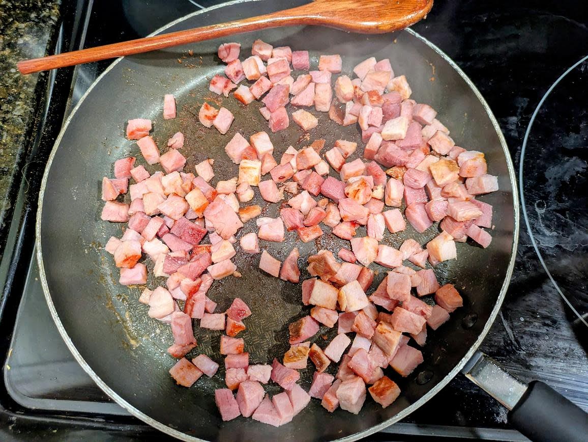 Heat a large pan over medium, and trim any fat off your ham, and cut into small cubes. When hot, add in your ham, and cook (uncovered) until the water cooks off and the ham begins to brown, about 10 minutes. Set the ham aside