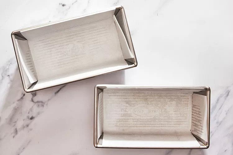 Preheat oven to 350°F. Grease and line 2 8 1/2- x 4 1/2-inch loaf pans with parchment paper; set aside.