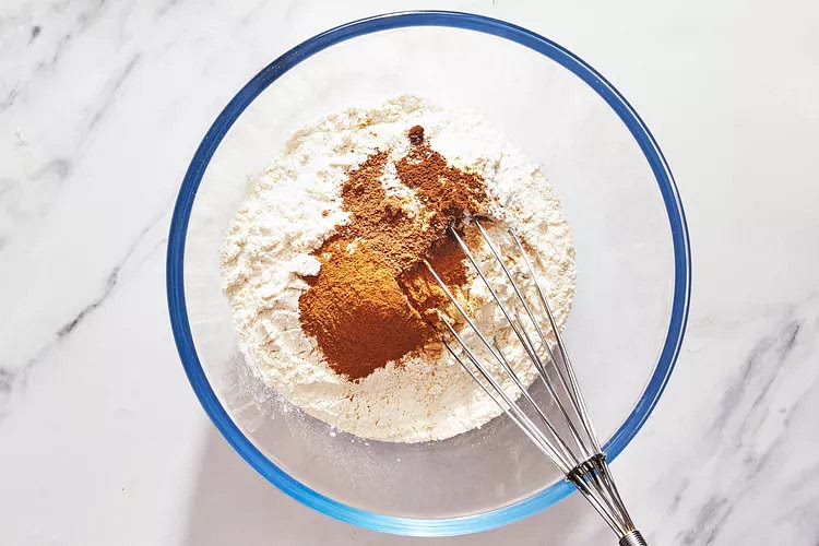 In a bowl, whisk together flour, baking powder, salt, baking soda, cinnamon, ginger, nutmeg, and cloves.