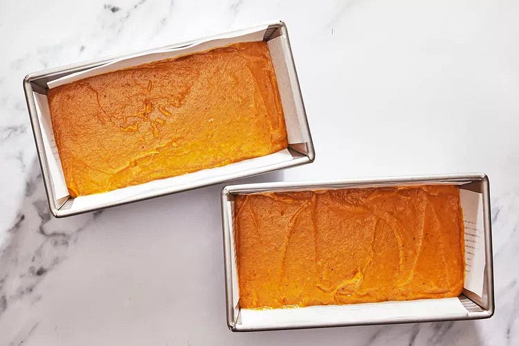 Divide batter evenly between prepared loaf pans.