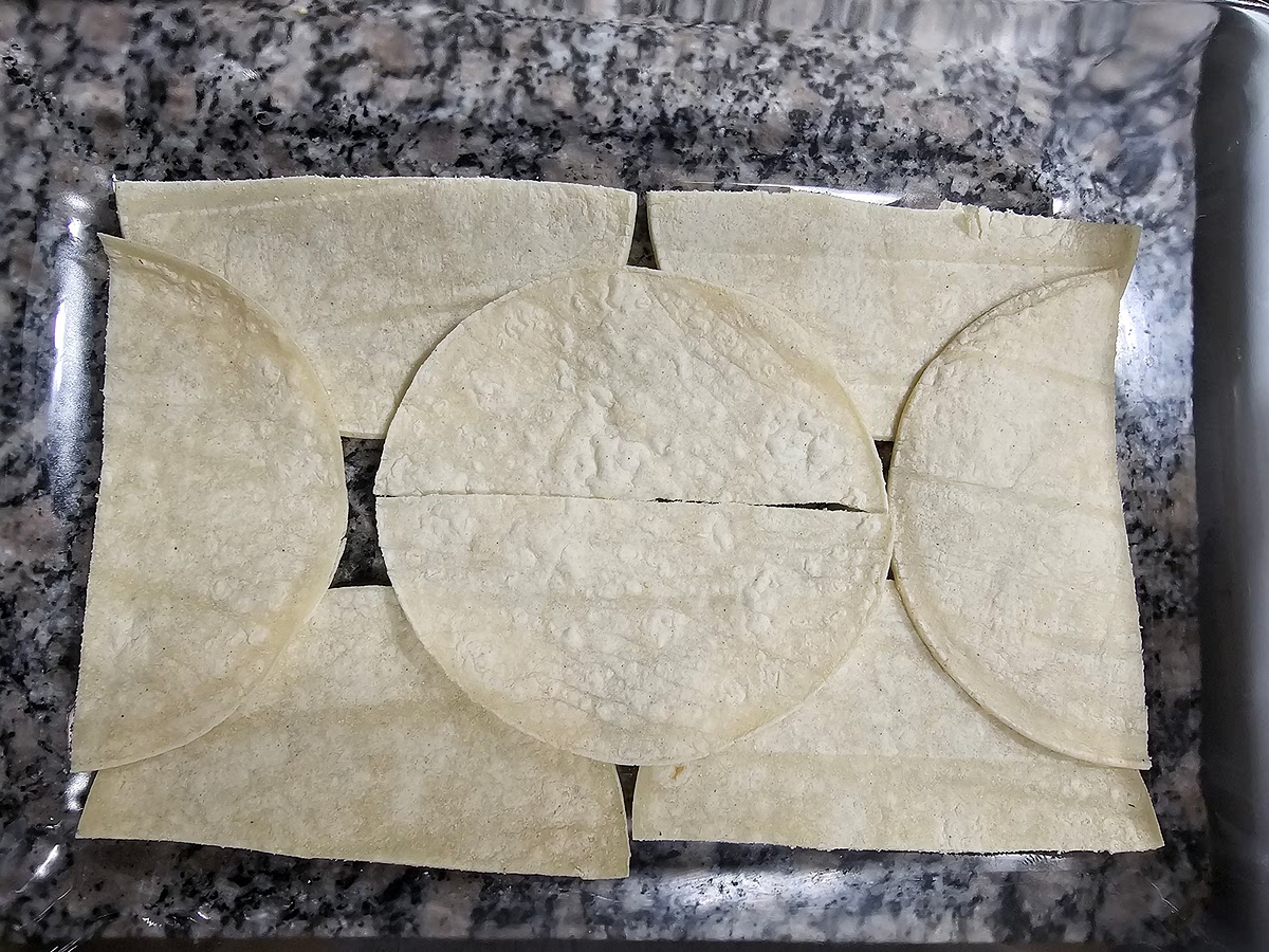 Make first layer of tortillas on bottom of dish, the flat side facing out