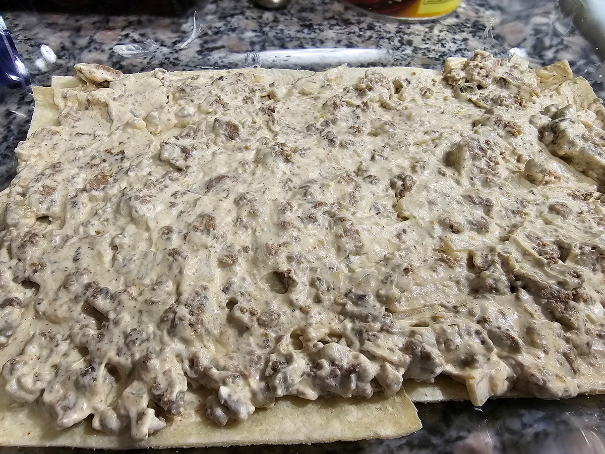 Split the mix into 3 sections and add one section on top of tortillas layer and spread