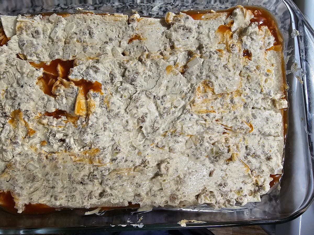 Last layer is tortillas, mix, sauce, cheese, I usually add extra cheese