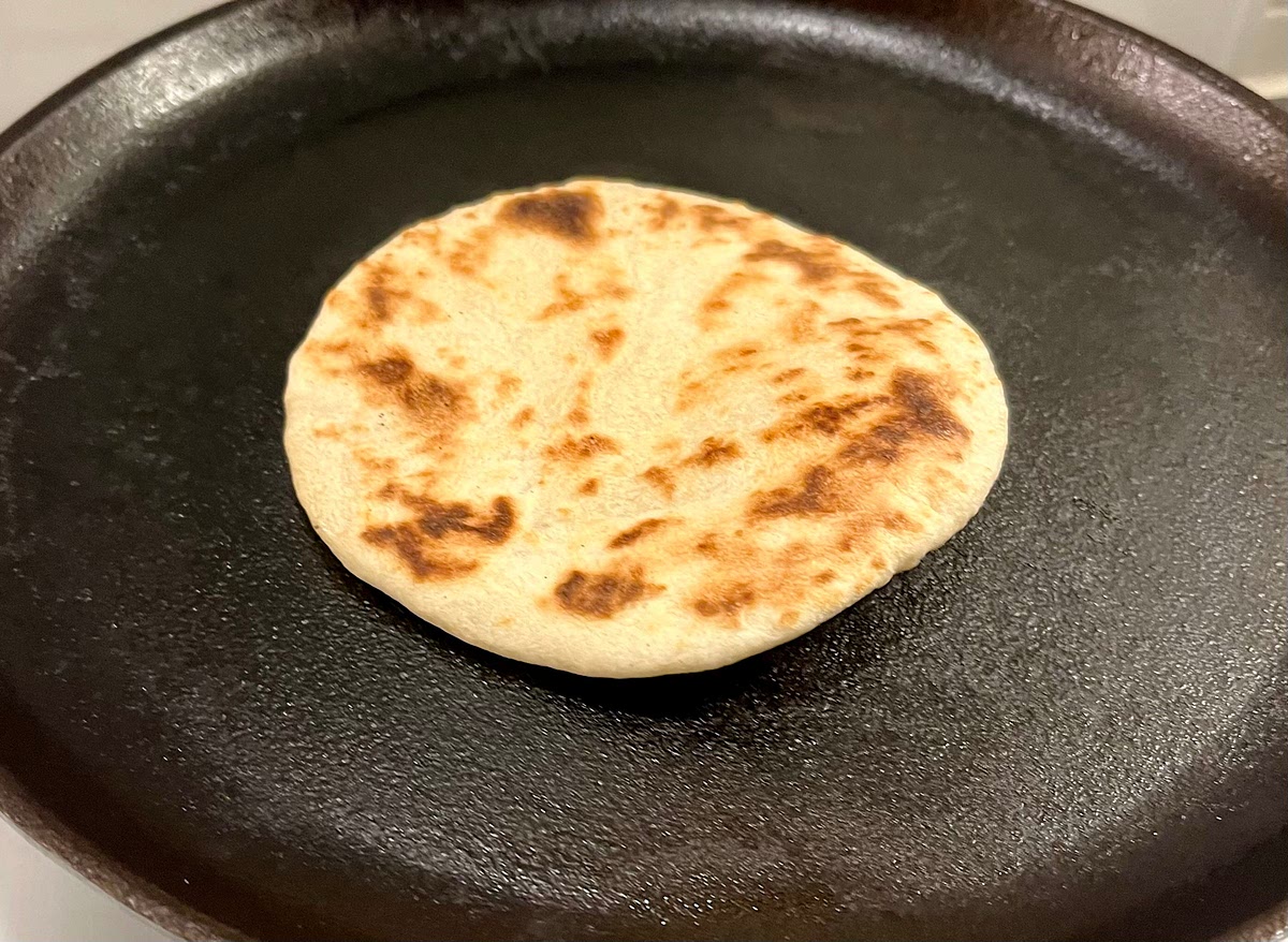Cook it on the hot skillet until little brown patches appear on the cooking side (1 to 1 ½ minutes), then flip it and cook it on the other side for about 40 seconds. It should slightly rise while cooking. I cook 2 at a time to speed up the process.