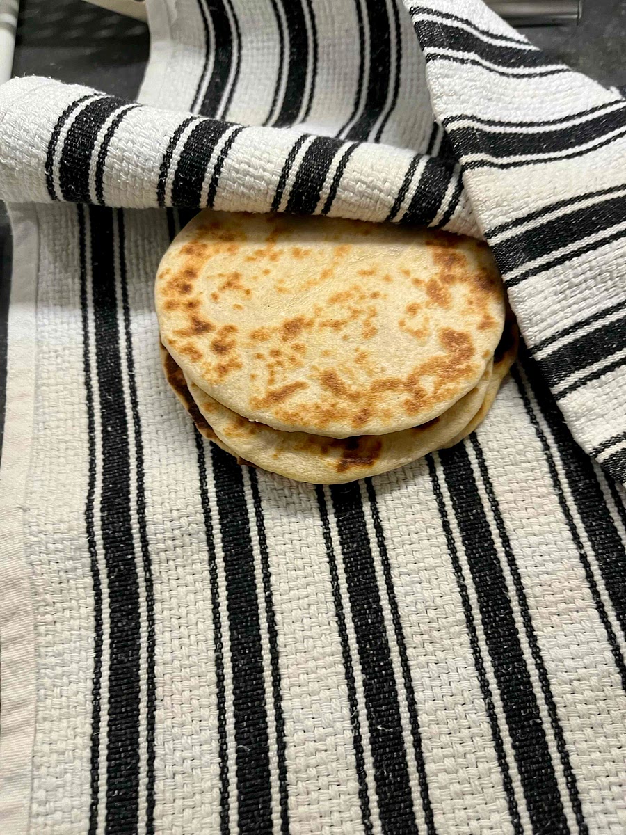 Put the cooked bread to cool down inside a tea towel, to keep them moist.